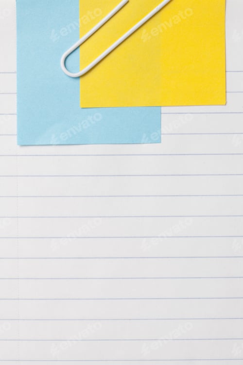 Preview: Close Up Image Of Sheet Of Paper With Adhesive Note And Paper Clip Against White Background