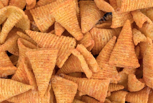 Preview: Close View Of Cheese Flavored Cone Shaped Corn Chips.