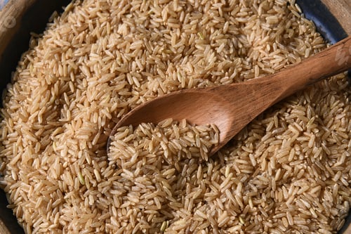 Preview: Closeup Of A Wooden Spoon In A Bowl Full Of Brown Rice.