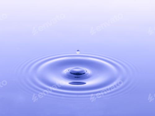 Water Drop Creating Ripples in Smooth Surface
