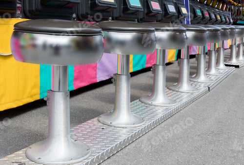 Preview: Round Stools By A Colorful Arcade Game Seats At A Fair Ground Midway