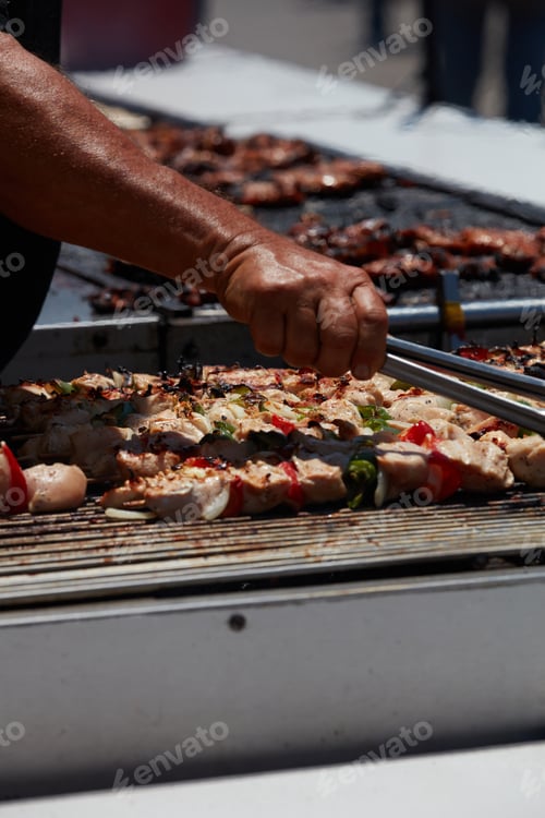 Preview: Barbecue Chicken Kabobs Being Grilled At An Amusement Park