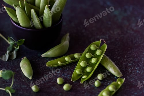 Preview: Close Up View Of Snap Pea Pods Against A Dark Background.