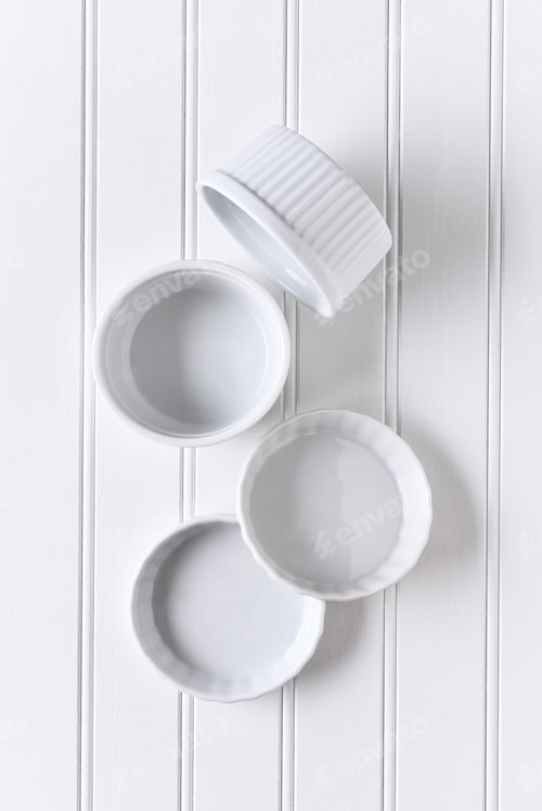 Preview: White On White Still Life Of A Group Of Ramekins Arranged On A Table. The Bowls Are Empty In