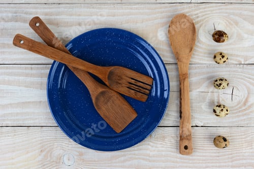 Preview: High Angle Shot Of A Blue Speckled Plated With Wooden Utensils And A Line Of Quail Eggs. Horizontal