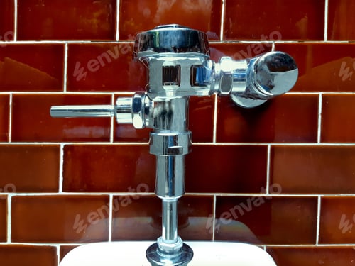 Preview: Urinal Flush Valve On A Red Tile Wall