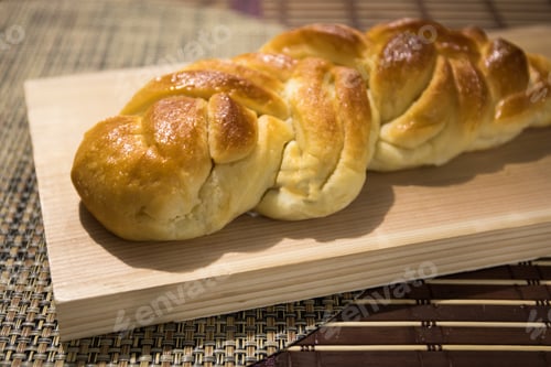 Preview: A Braided Loaf Of Egg Bread On A Wooden Board