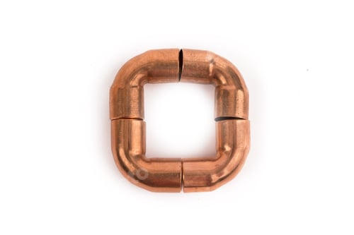 Preview: Copper Plumbing Elbows Whimsically Arranged In A Square Isolated On White