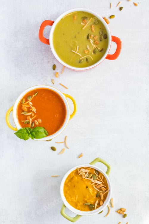 Preview: A Top Down View Of Three Bowls Of Hot Soup Garnished With Pumpkin Seeds And Crispy Dried Noodles