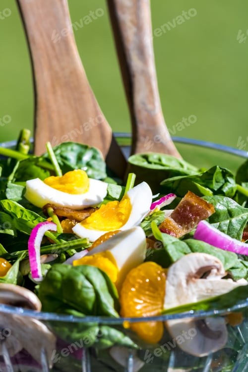 Preview: Close Up View Of A Spinach Salad On An Outdoor Patio Table On A Sunny Day.