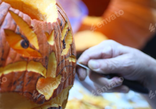 Preview: A Man Carves An Intricate Face On A Halloween Jack O' Lantern.
