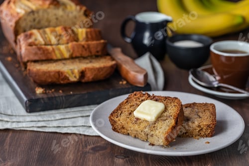Preview: Close Up Of Slices Of Banana Bread With Butter Surrounded By A Banana Loaf, Bananas And Coffee.