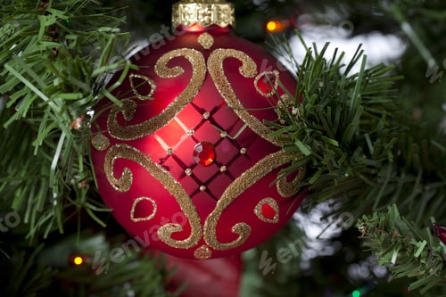 Preview: Close-Up Shot Of Shiny Design On Red Christmas Bauble Hanging On Christmas Tree.