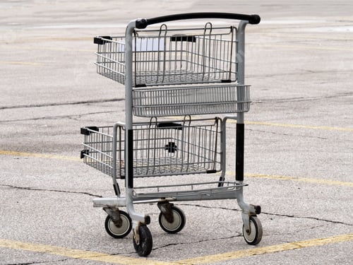 Preview: An Empty Shopping Cart Abandoned On A Parking Lot