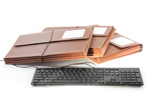 Preview: A Stack Of Three Brown Accordion File Folders With Blank Labels By A Computer Keyboard Isolated On
