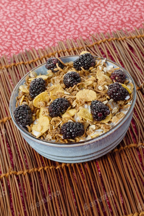 Preview: Bowl Full Of Blackberry Fruit And Cornflakes On Mat For Breakfast