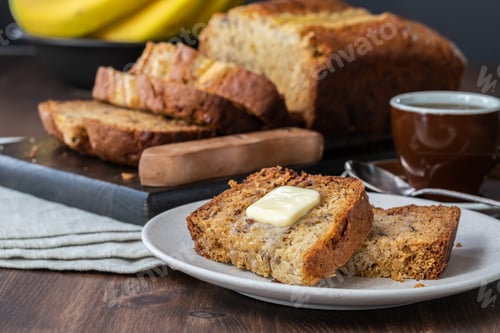 Preview: Close Up Of Slices Of Banana Bread With Butter On A Small Plate With A Sliced Banana Bread Loaf In