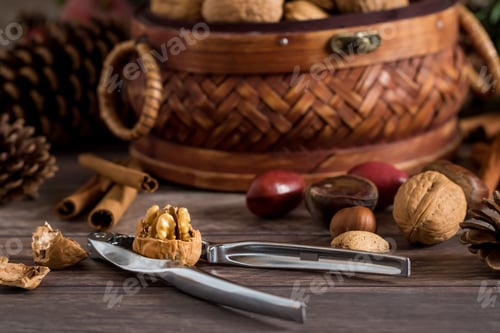 Preview: A Close Up View Of A Basket Filled With Mixed Nuts With A Walnut Cracked Open In Front.