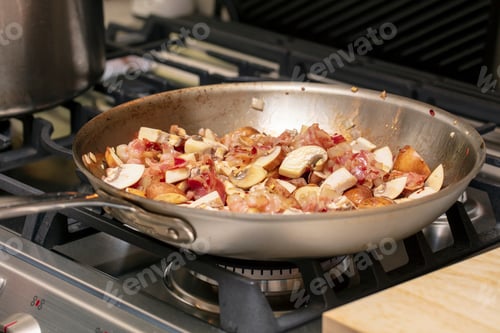 Preview: Pasta Cream Sauce Made With Pancetta, Mushrooms, Tomato And Onions In A Fry Pan On The Stove