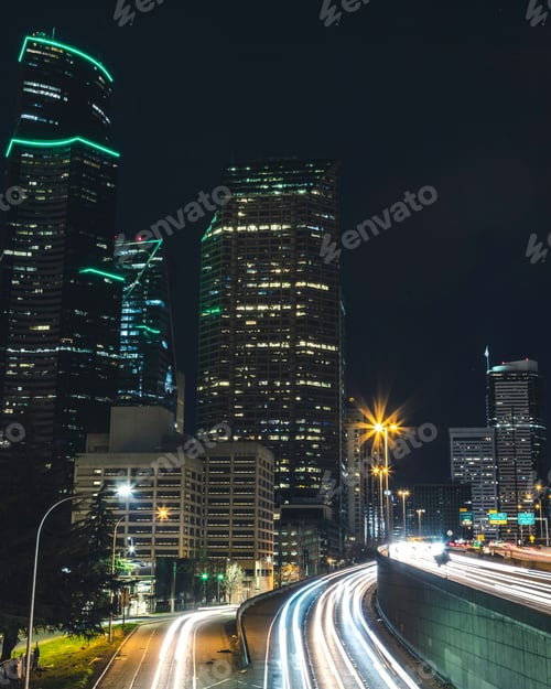 Preview: Seattle Cityscape Skyscraper Buildings Above Freeway Long Exposure Car Streaks At Night