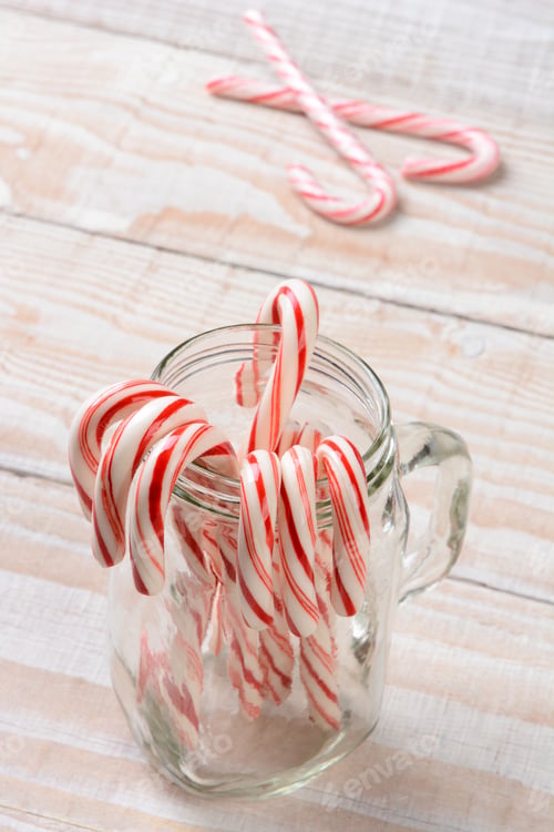 Preview: A Jar Of Candy Canes On A Wood Table. High Angle Shot With Shallow Depth Of Field.
