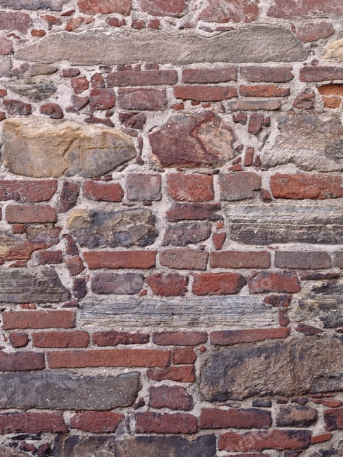 Preview: Clean Image Of Old World Wall With Red Bricks, Raw Stone And Various Block Of Different Shapes And