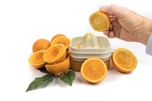 Preview: A Man Holding An Orange Ready To Make Orange Juice With An Orange Juicer Isolated On White