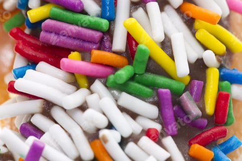 Preview: Brightly Colored Sprinkles Topping a Sweet Donut