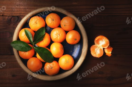 Preview: Flat Lay Image Of A Plate Of Fresh Picked Mandarin Oranges In A Rustic Wood Table With One Peeled