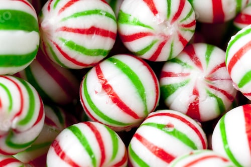 Preview: Close-Up Shot Of Heap Of Colorful Peppermint Candies With Green And Red Stripes.
