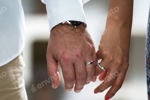 Preview: Close Up Of The Hands Of A Couple Wearing Their Wedding Bands