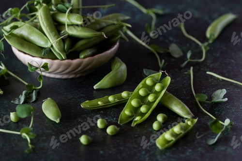 Preview: Close Up View Of Snap Pea Pods Against A Dark Background.