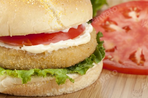 Preview: Cropped Image Of Crispy Chicken Sandwich On A Wooden Table