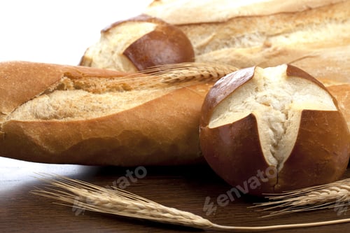 Preview: Close Up Image Of Baguette Bread With Buns Against White Background