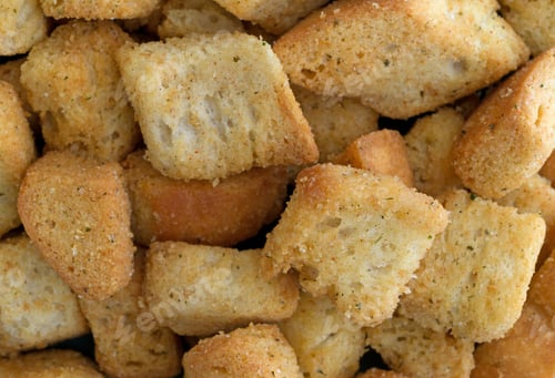Preview: A Close View Of Large Seasoned Croutons Illuminated With Natural Light.