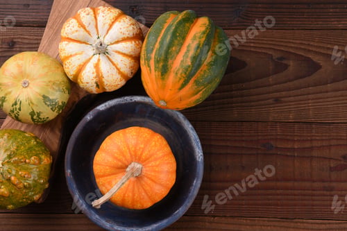 Preview: High Angle Shot Of A Group Of Ornamental Pumpkins And Gourds On A Rustic Wood Table.