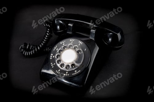Preview: Angle View Of An Old Fashioned Black Rotary Telephone On A Black Backgroun