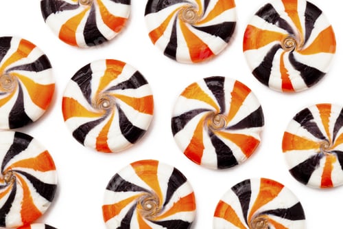 Preview: Close-Up Shot Of Colorful Hard Candies With Swirl Design Over White Background.