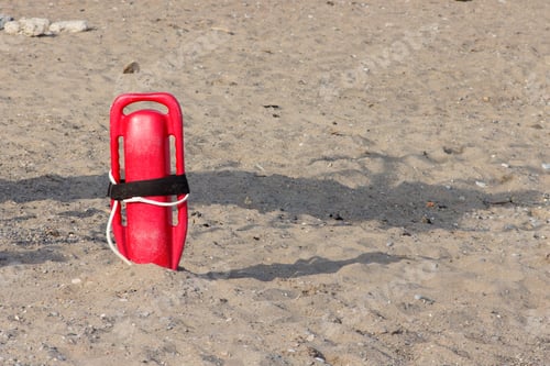 Preview: A Red Lifegaurd'S Rescue Float Stuck In The Sand On A Beach