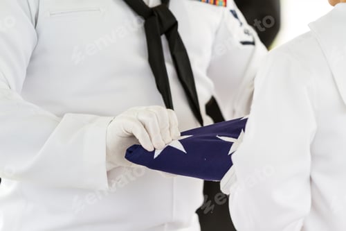 Preview: Active Navy Representatives Folding A Flag As Part Of A Ceremony For A Veterans Funeral