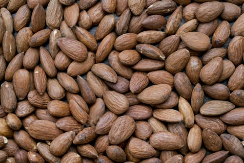 Preview: Close-Up Image Of A Pile Of Almond Nuts On The Wooden Table