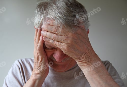 Preview: Older Man With His Hands On Forehead And Side Of Face