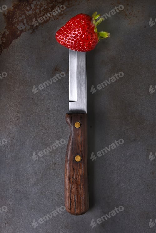 Preview: Still Life Of A Fresh Picked Strawberry Stuck On The End Of A Knife.