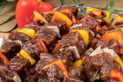 Preview: A Tray Of Beef Tenderloin Skewers Or Shish Kebabs With Red And Yellow Peppers And Onion Pieces On