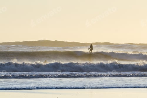 Preview: Surfing In The Cold Pacific Waters Of The Oregon Coast As The Sun Sets Casting A Strong Backlight