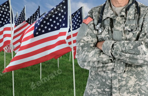 Preview: Closeup Of A American Soldier / Medic In Front Of A Large Group Of American Flags In A Field Of