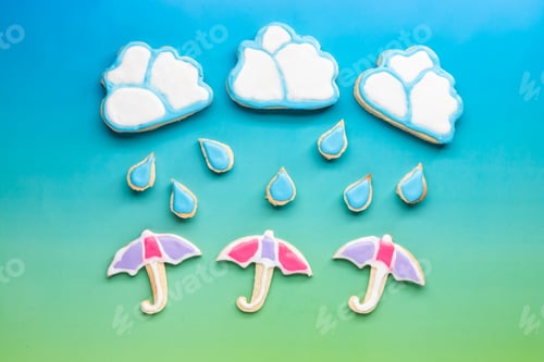 Preview: Top Down View Of Sugar Cookies In Shapes Of Clouds, Raindrops And Umbrellas. A Spring Concept.