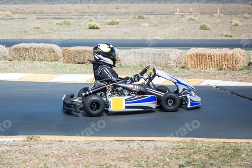 Preview: Young Kid Racing A Go Cart Around A Track