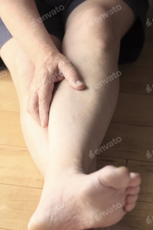 Preview: A Man On The Floor Puts A Hand On His Sore Calf.