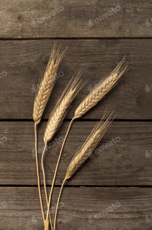 Preview: Gold Wheat Lying On A Brown Wooden Surface